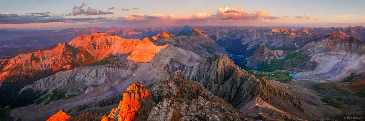 Panoramic view of sunset alpenglow lighting the San Juan Mountains, as seen from the 14,150ft. summit of Mt. Sneffels.
